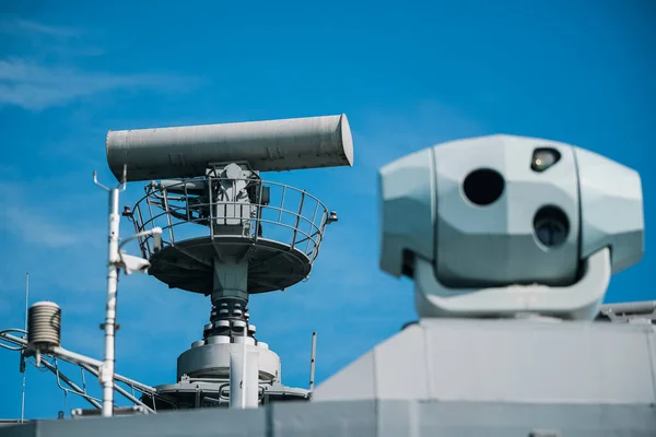 uImage of  a military radar air surveillance on navy ship tower.