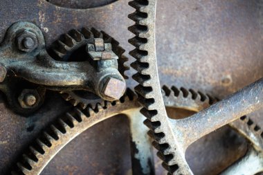 Rusty large gears from old mechanism photographed at close range.