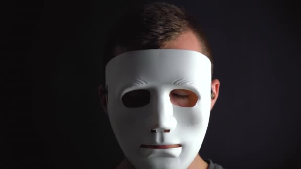 Man takes off the mask hiding his face Stock Video