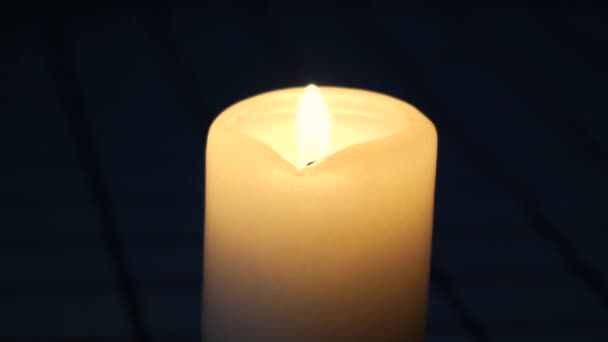 Wax candle on dim background — Stock Video