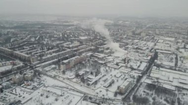 harsh cloudy city in the snow. 4k drone footage