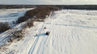 black SUV driving off-road. 4k drone footage
