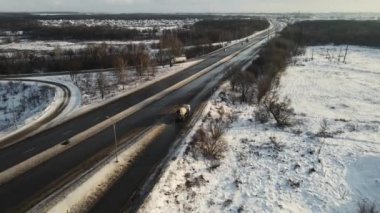 concrete mixer is driving on the highway in winter. 4k aerial footage