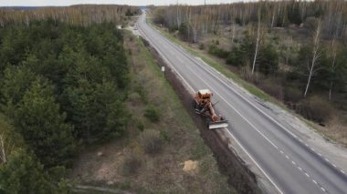 tractor repairs road view from a height. 4k footage