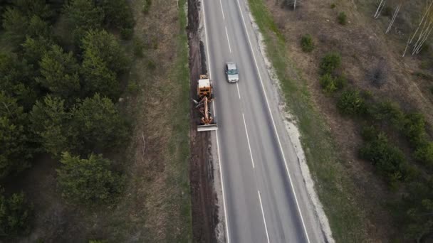 A view from a height of the tractor repairing the road. 4k footage — Stockvideo