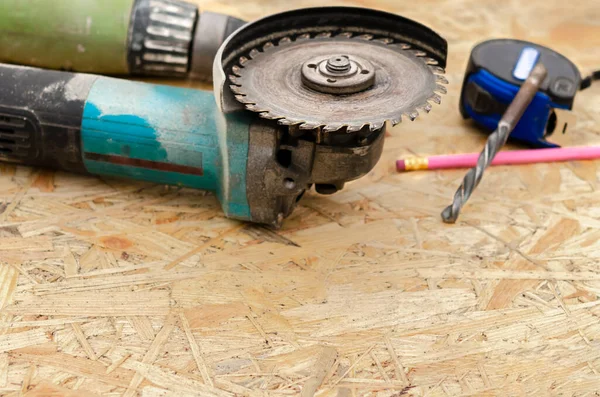 Worker hand holding angle grinder with diamond cutting disc for concrete ready to saw a cement slab. Cutting metal angle grinder, sparks from the disk. Space for text