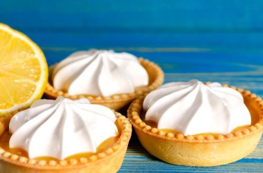 Limonlu turtalar, ev yapımı mini tart kekleri limonlu ve kremşantili, mavi arka plan fotokopi alanı