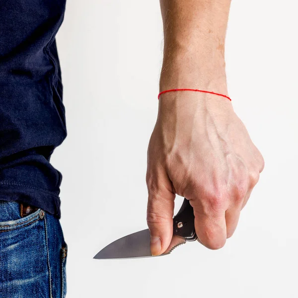 The man using folding knife. Close up folding knife in hand. EDC for men concept.