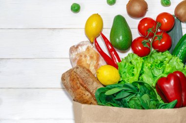 Sağlıklı beslenme geçmişi. Kağıt torba içinde vejetaryen yemekler, beyaz üzerinde sebzeler, fotokopi alanı, afiş. Süpermarket alışverişi ve temiz vegan yeme konsepti..