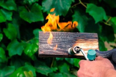 Geleneksel tekniği kullanan profesyonel bir marangoz. Gaz ocağıyla odun yakmak. DIY süreci.