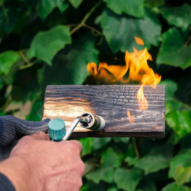 Geleneksel tekniği kullanan profesyonel bir marangoz. Gaz ocağıyla odun yakmak. DIY süreci.