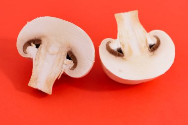 Mushrooms champignons on a red background View from above. Fresh raw mushroom. Food. Cooking. Veganism.