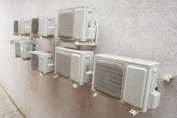 Air conditioner machines on old wall. Air condition system outdoor unit.