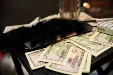US Dollars scattered on a table as a theme party decoration. Mafia party celebration of a special event. Creative people. Money on a table .
