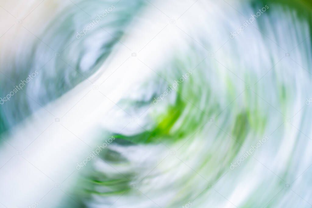 Fresh abstract background in shades of blue and green with highlights and swirls in the center of the image