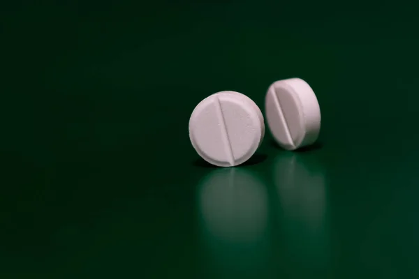 Two White Pills Green Background Stand Side Medical Theme Selective — Stock Photo, Image