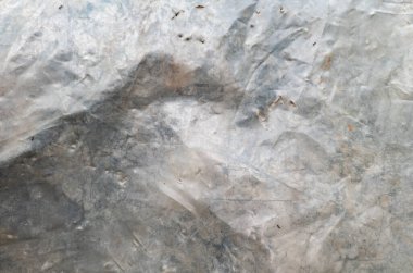 Eski, buruşuk, kirli polietilen geçmişi. Gri çizgiler ve lekeler. Arkaplan