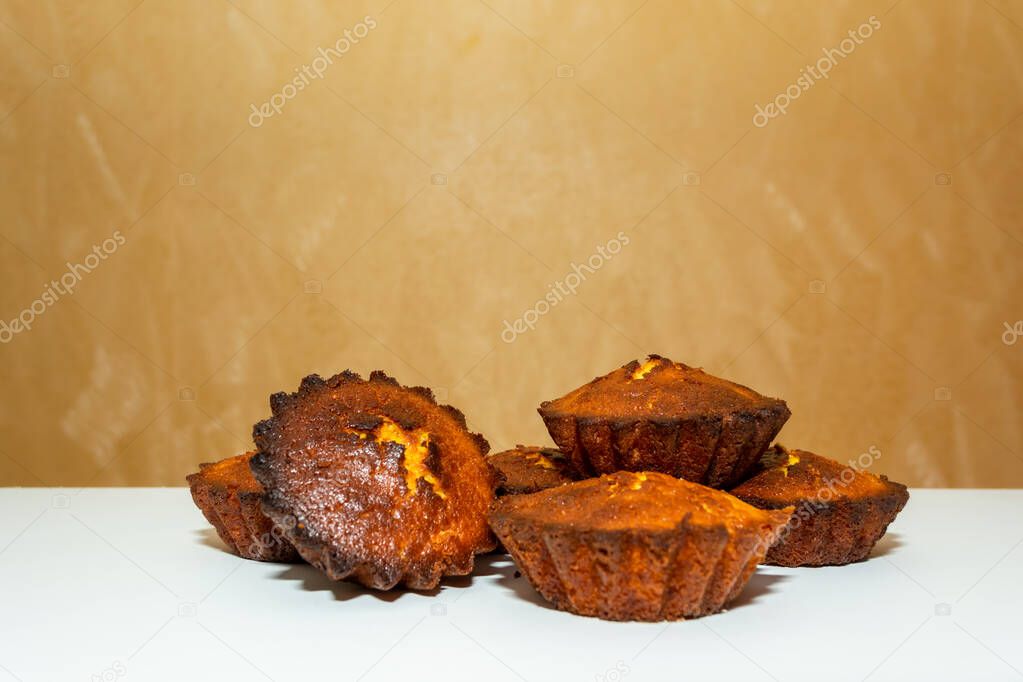 Freshly baked cupcakes on a white table. Home cooking. Delicious pastries.
