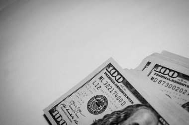 100 dollar American bills. Black and white photo with vining.