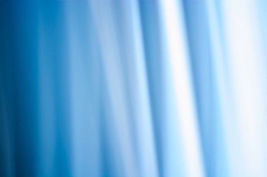 Abstract background in cold shades, curtain in blue colors with soft blur and highlights. Backdrop