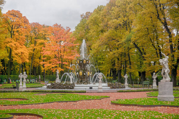 Beautiful autumn summer garden with fountains in St. Petersburg in Russia.