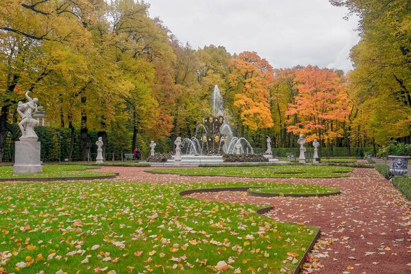 Beautiful autumn summer garden with fountains in St. Petersburg in Russia.