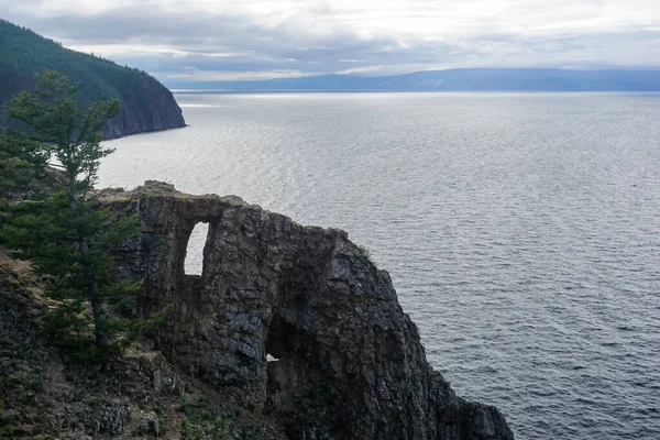 Natural window in the rock on the Olkhon Island at Baikal