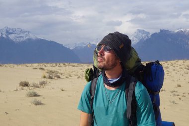 Chara kum tepelerindeki gezgin ve Kodar sırtına bakan.