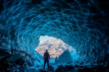 Man inside an ice cave clipart