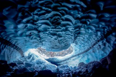 Inside a cold ice cave in Kamchatka peninsula in Russia clipart