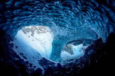 Inside a cold ice cave in Kamchatka peninsula in Russia clipart