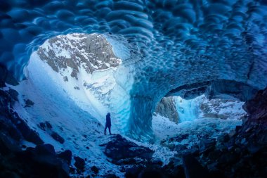 Man inside an ice cave clipart