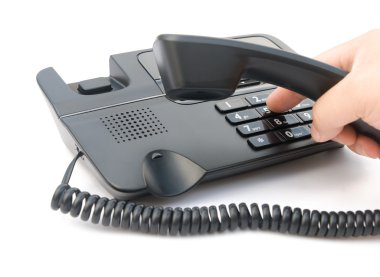 Man dialing a telephone with clipping path clipart