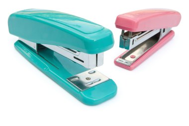 Blue and pink staplers with clipping path clipart