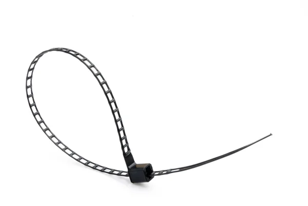 Pętla kształt czarny plastikowy kabel krawat na białym — Zdjęcie stockowe