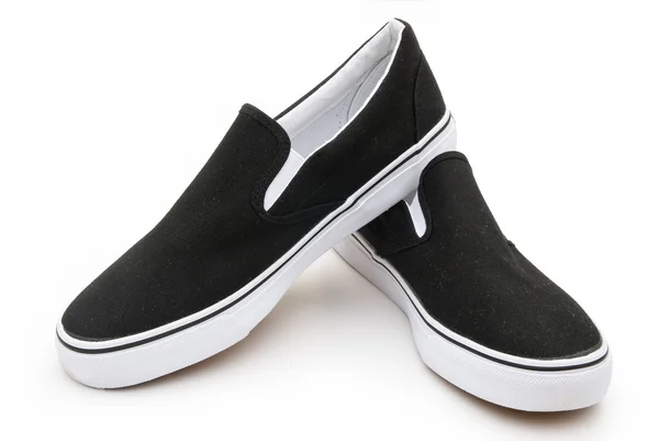 Paar zwarte sneakers op wit — Stockfoto