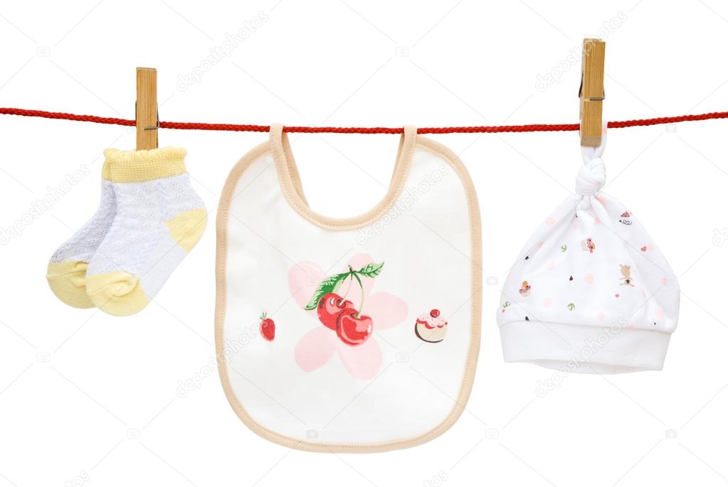 Baby socks and bib and cap hanging with clipping path