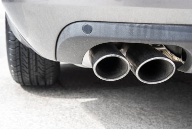 Exhaust pipe of a silver car clipart