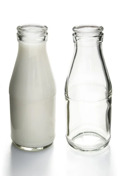 Full and empty milk bottles with clipping path — Stock Photo, Image