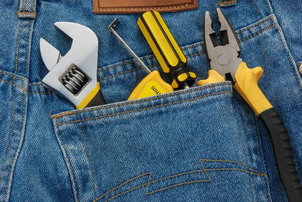 Tools in a blue jean back pocket — Stock Photo, Image