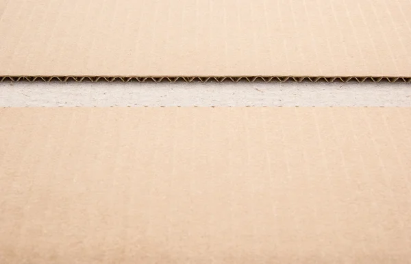 Cardboard with a cut off setion — Stock Photo, Image