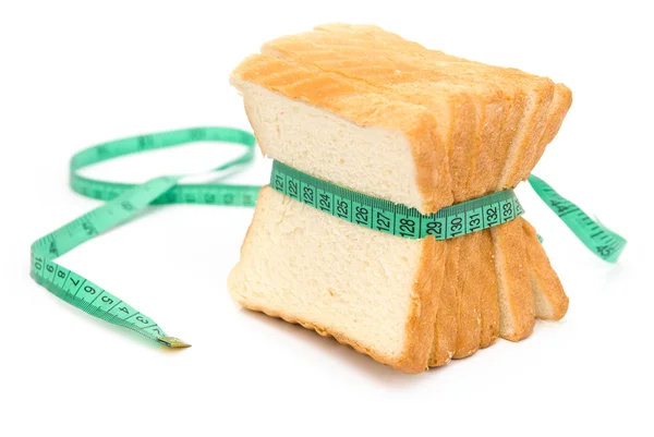 Bread grasped by measuring tape — Stock Photo, Image