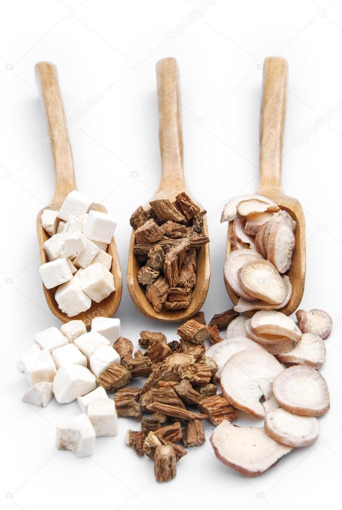 chinese herbs on wooden spoons,vertical