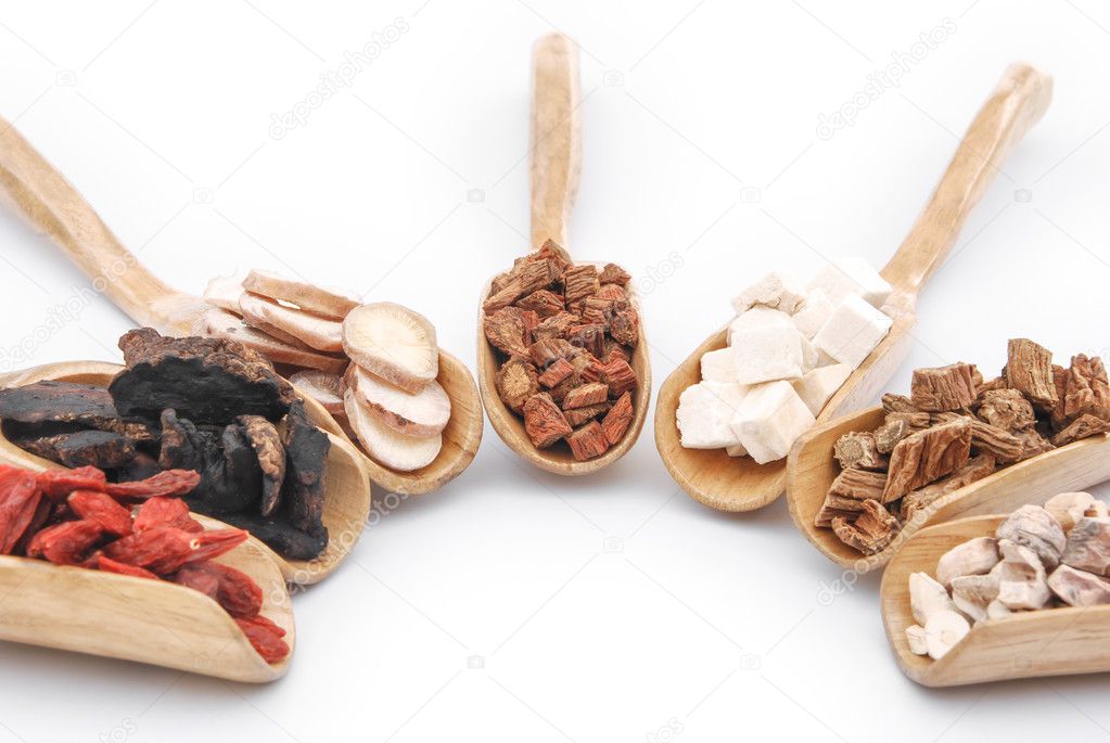 chinese herbs on wooden spoons