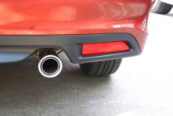 Exhaust pipe of a red car close up — Stock Photo, Image