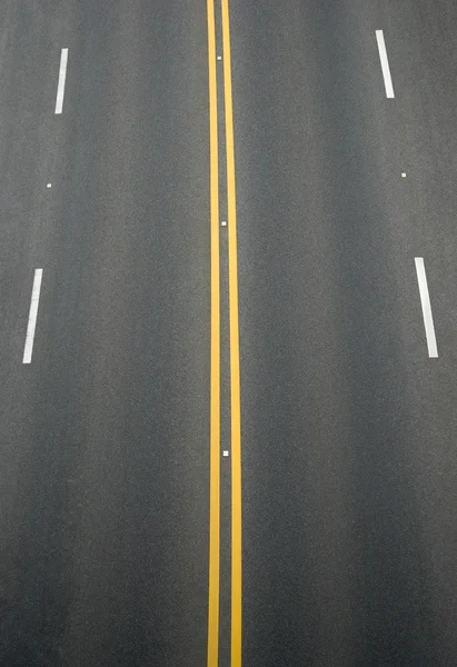 Dubbele gele lijnen en witte lijnen scheidingslijn op blacktop — Stockfoto