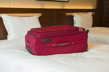 yatakta bir otel oda içinde kırmızı çanta