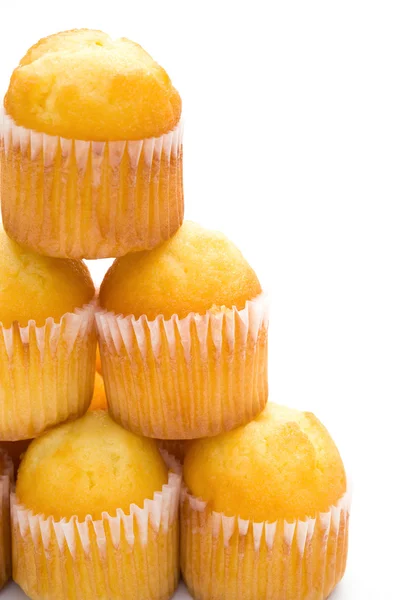 Cup cakes stack up on a white background with copy space, vertical — Stock Photo, Image