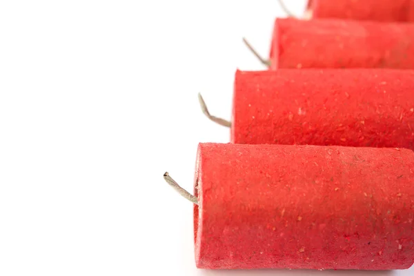 Red firecrackers on a white background with copy space — Stock Photo, Image