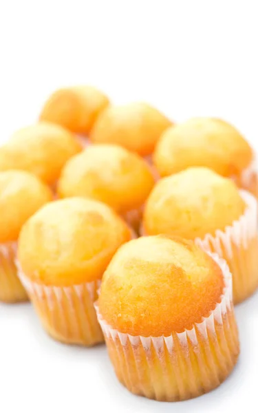 Golden cup cakes on a white background — Stock Photo, Image